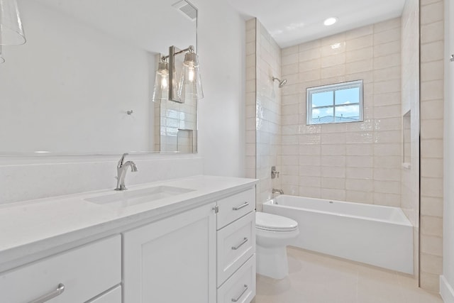 full bathroom featuring tiled shower / bath, vanity, toilet, and tile patterned floors