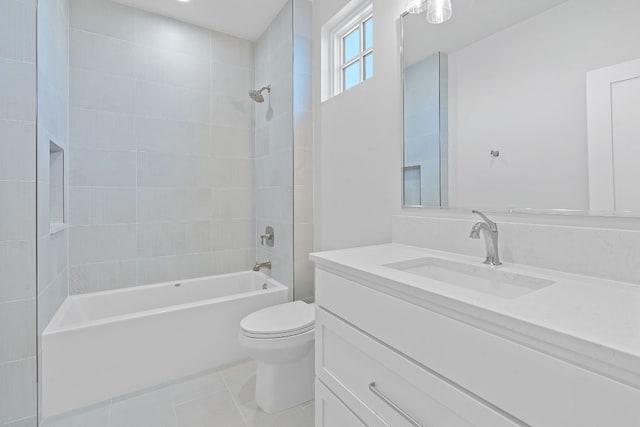 full bathroom featuring vanity, tiled shower / bath combo, toilet, and tile patterned flooring