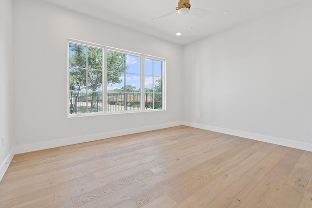 spare room featuring ceiling fan and light hardwood / wood-style flooring