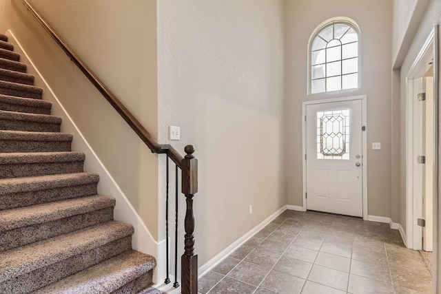 tiled entryway with a high ceiling