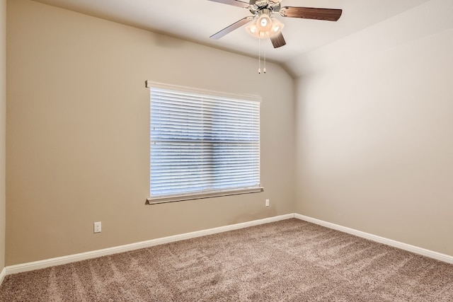 carpeted spare room featuring ceiling fan and lofted ceiling