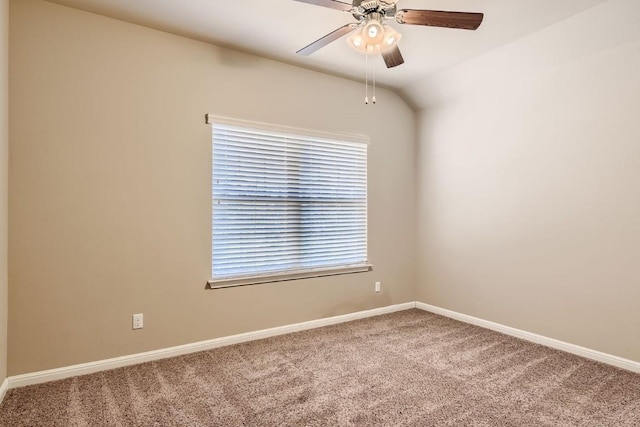 spare room featuring ceiling fan, baseboards, vaulted ceiling, and carpet flooring