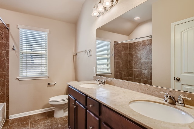 bathroom with vanity, toilet, and vaulted ceiling