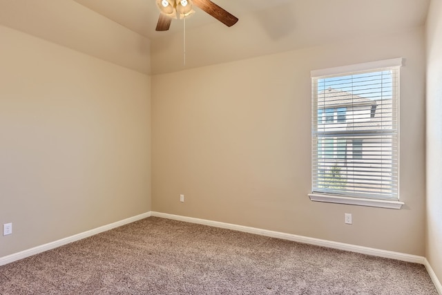 carpeted spare room featuring ceiling fan