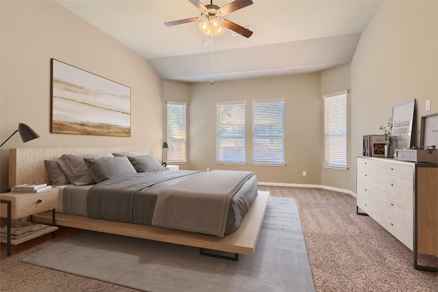 carpeted bedroom with a ceiling fan, lofted ceiling, and baseboards