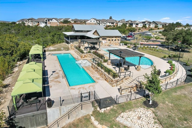 community pool featuring fence and a residential view