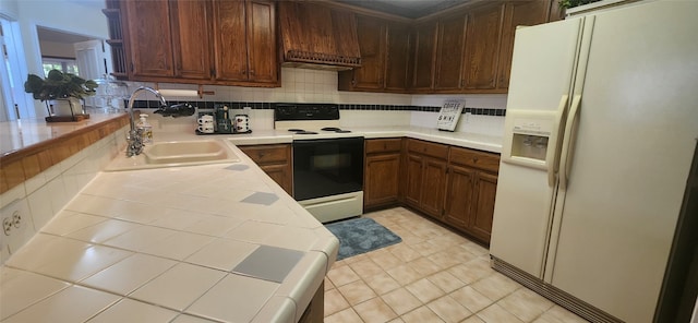 kitchen featuring white appliances, light tile patterned flooring, tasteful backsplash, and sink