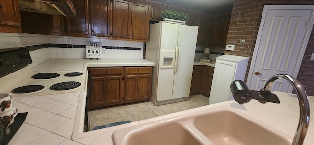 kitchen featuring custom range hood, backsplash, white appliances, dark brown cabinets, and sink