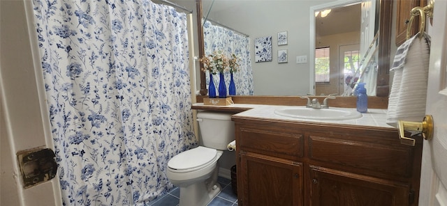 bathroom featuring a shower with curtain, vanity, tile patterned flooring, and toilet