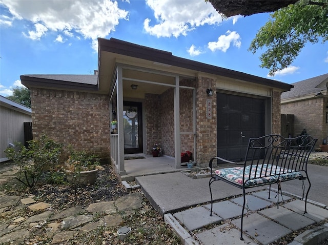 rear view of house featuring a garage