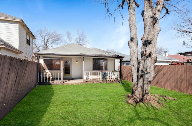 back of house with a lawn