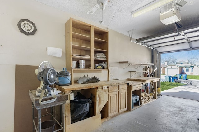 garage featuring ceiling fan and a workshop area