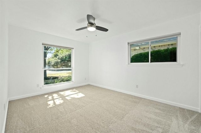 carpeted empty room featuring ceiling fan