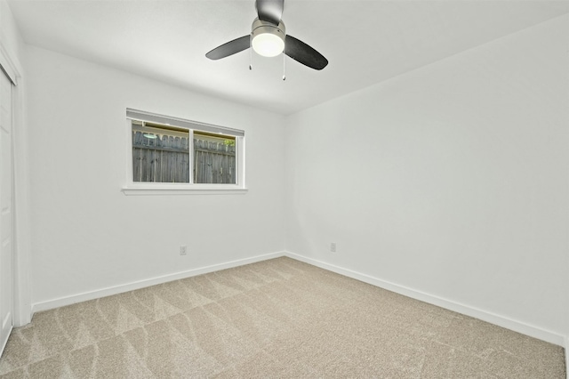 carpeted empty room with ceiling fan