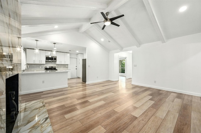 unfurnished living room with light hardwood / wood-style flooring, vaulted ceiling with beams, ceiling fan, and sink