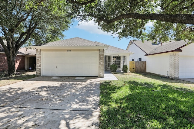 ranch-style house with a front yard and a garage