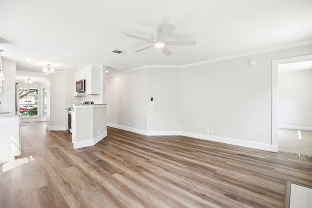 unfurnished living room with light hardwood / wood-style flooring, ceiling fan, ornamental molding, and sink