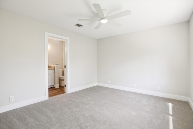 unfurnished bedroom with ceiling fan, connected bathroom, and carpet flooring