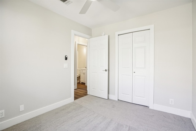 unfurnished bedroom with a closet, ceiling fan, and light colored carpet