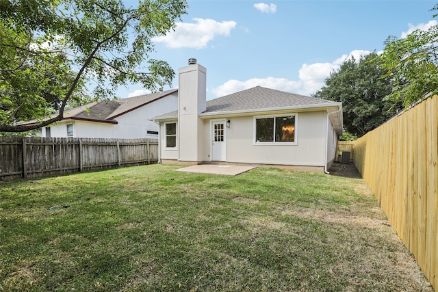 rear view of house with a yard and a patio