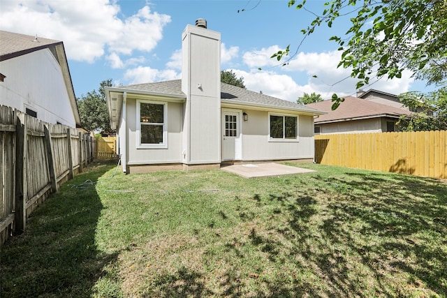 back of house with a yard and a patio area