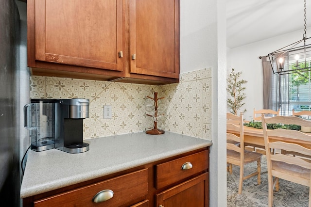 7709 Little Deer Trl, Georgetown, TX 78628 - kitchen featuring a chandelier, brown cabinets, and light countertops