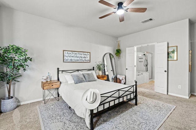 carpeted bedroom with ensuite bath and ceiling fan