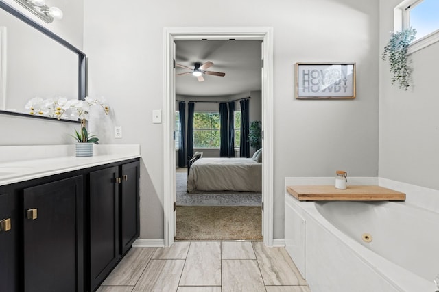 7709 Little Deer Trl, Georgetown, TX 78628 - ensuite bathroom with connected bathroom, a whirlpool tub, vanity, baseboards, and a ceiling fan