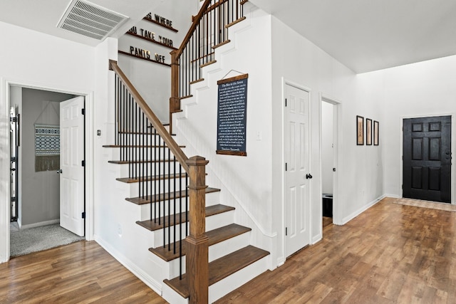7709 Little Deer Trl, Georgetown, TX 78628 - stairs featuring wood finished floors, visible vents, and baseboards