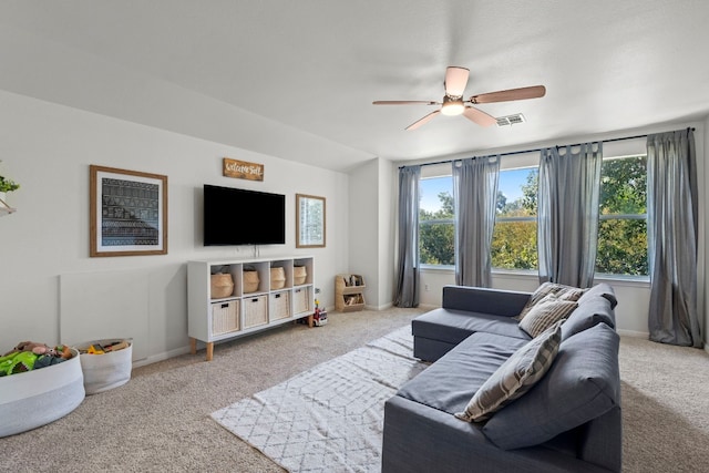 carpeted living room with a ceiling fan, visible vents, and baseboards