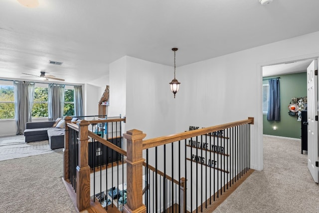 7709 Little Deer Trl, Georgetown, TX 78628 - hall featuring an upstairs landing, visible vents, carpet, and baseboards