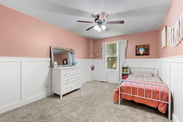 7709 Little Deer Trl, Georgetown, TX 78628 - bedroom with ceiling fan, a wainscoted wall, carpet, and a decorative wall