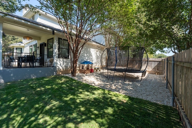 view of yard with a fenced backyard and a trampoline