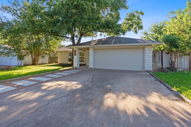 view of front of home featuring a front yard and a garage