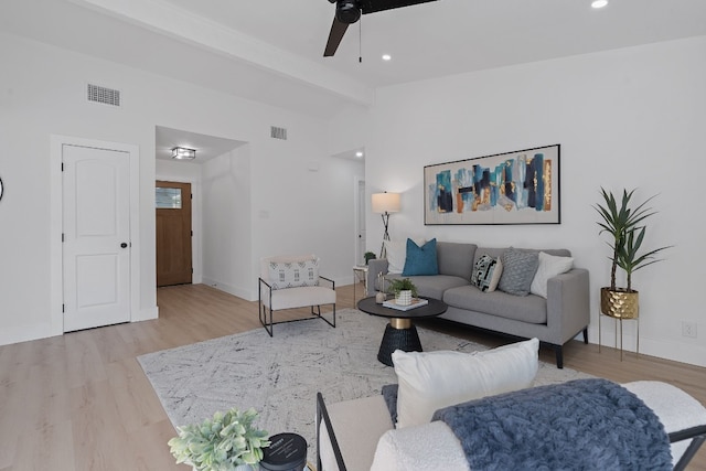 living room with ceiling fan, beam ceiling, and hardwood / wood-style floors