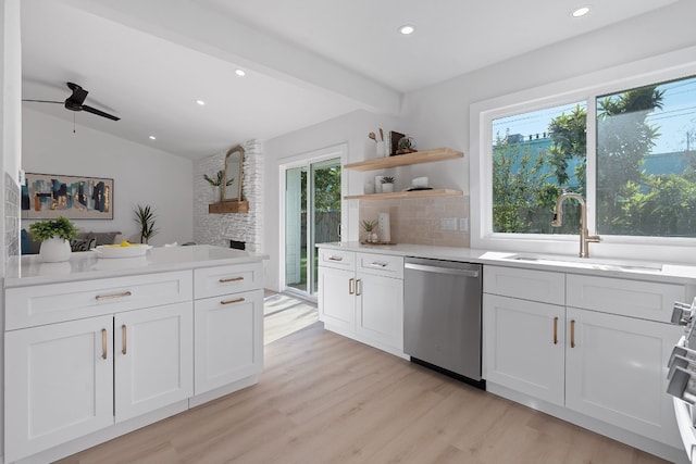 kitchen with vaulted ceiling with beams, white cabinets, sink, dishwasher, and light hardwood / wood-style floors