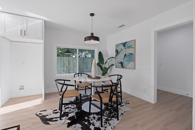 dining space with light wood-type flooring