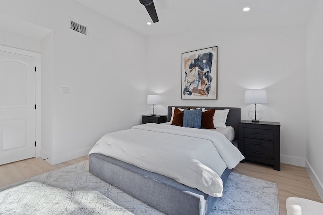 bedroom with light hardwood / wood-style floors and ceiling fan