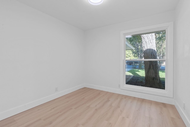 unfurnished room with light wood-type flooring