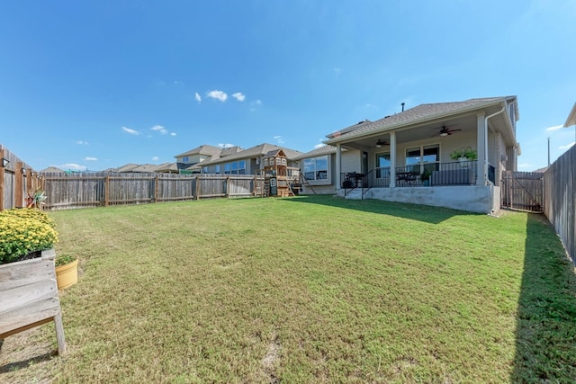 view of yard featuring ceiling fan and a patio area