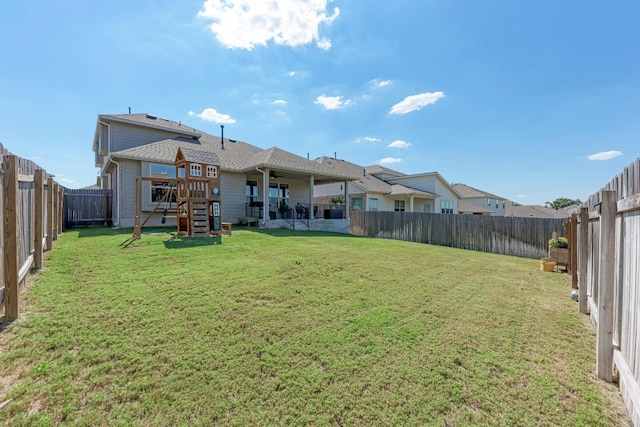 back of house featuring a patio and a yard