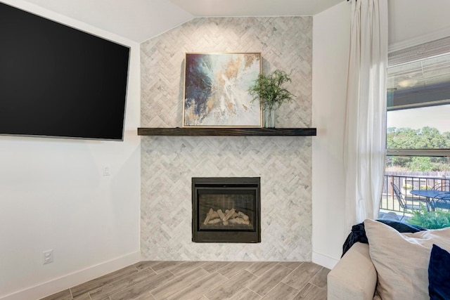 interior details with a tiled fireplace and hardwood / wood-style flooring