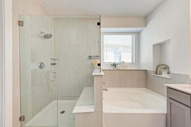 bathroom featuring vanity and plus walk in shower