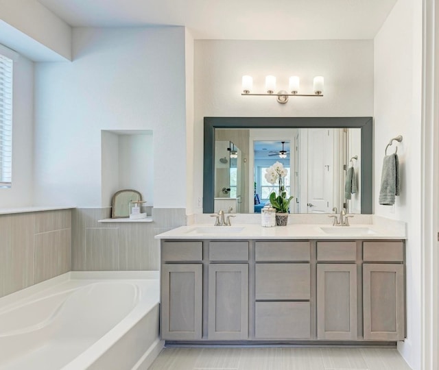 bathroom with vanity and a bath