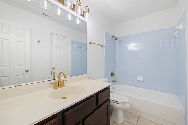 full bathroom with toilet, tiled shower / bath, tile patterned floors, and vanity