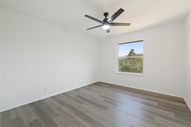 empty room with ceiling fan and dark hardwood / wood-style flooring