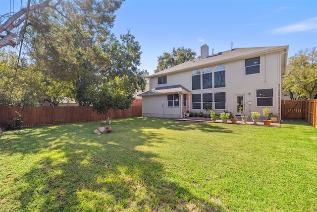 rear view of property with a yard