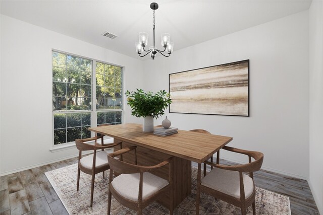 dining room featuring an inviting chandelier and hardwood / wood-style floors