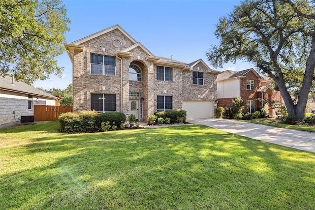 view of front facade featuring a front yard, a garage, and central AC unit