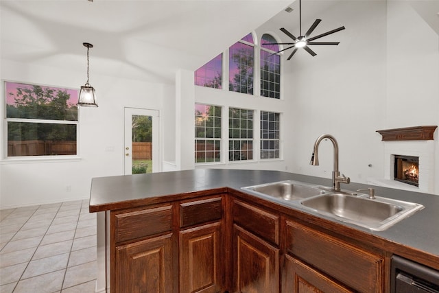 kitchen featuring pendant lighting, dishwasher, sink, ceiling fan, and light tile patterned floors